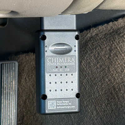 Chimera tuner plugged into the OBDII port under the dash of a 6.0 Powerstroke